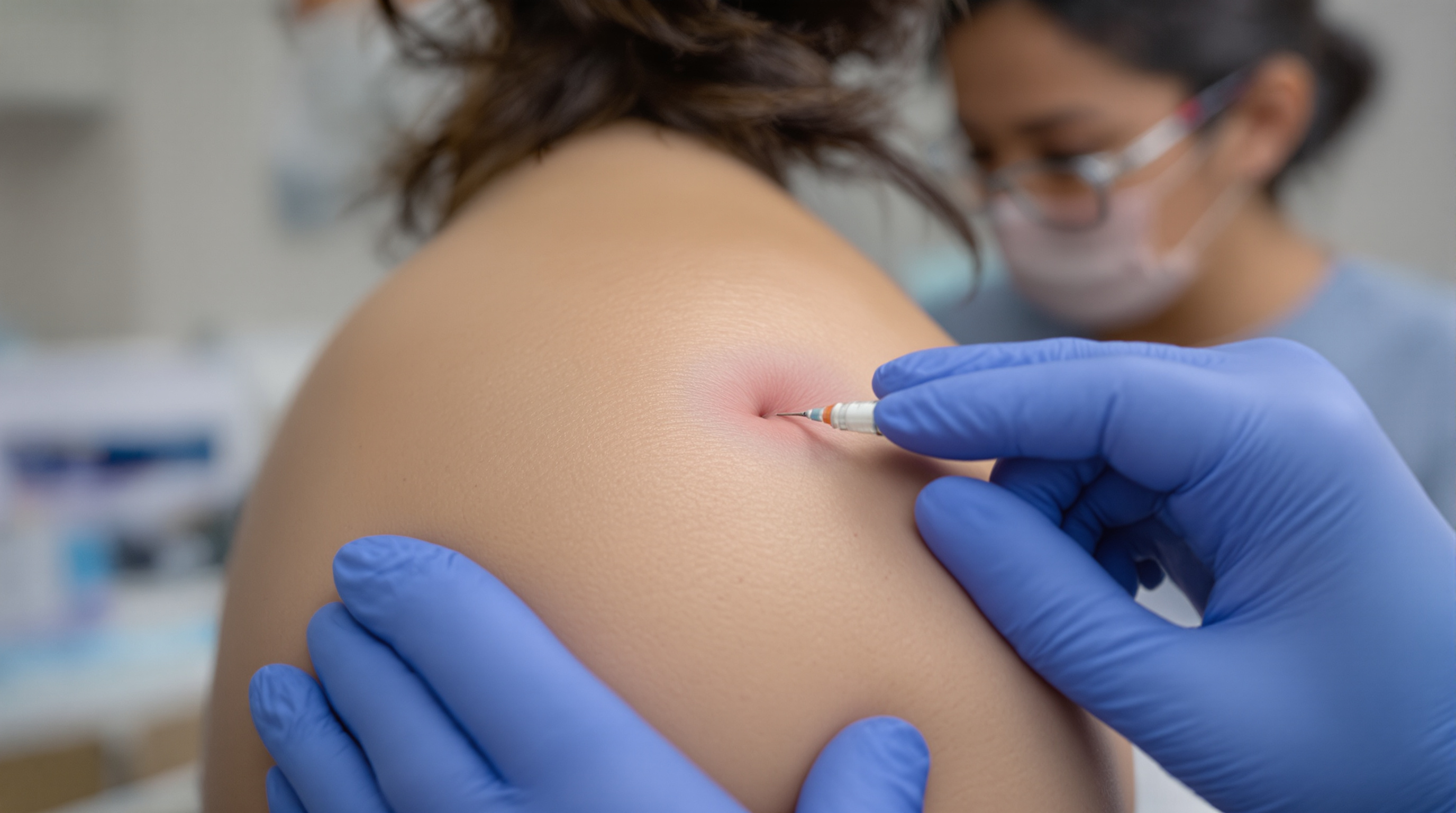 A woman examining the skin on her upper chest closely in a mirror in soft daylight
